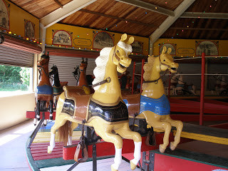 the_dickinson_county_heritage_centers_1901_parker_carousel_notice_that_the_horses_are_simply_adorned_and_move_on_a_rocking_mechanism_these_were_common_features_of_parkers_carousels_made_in_abilene.jpg